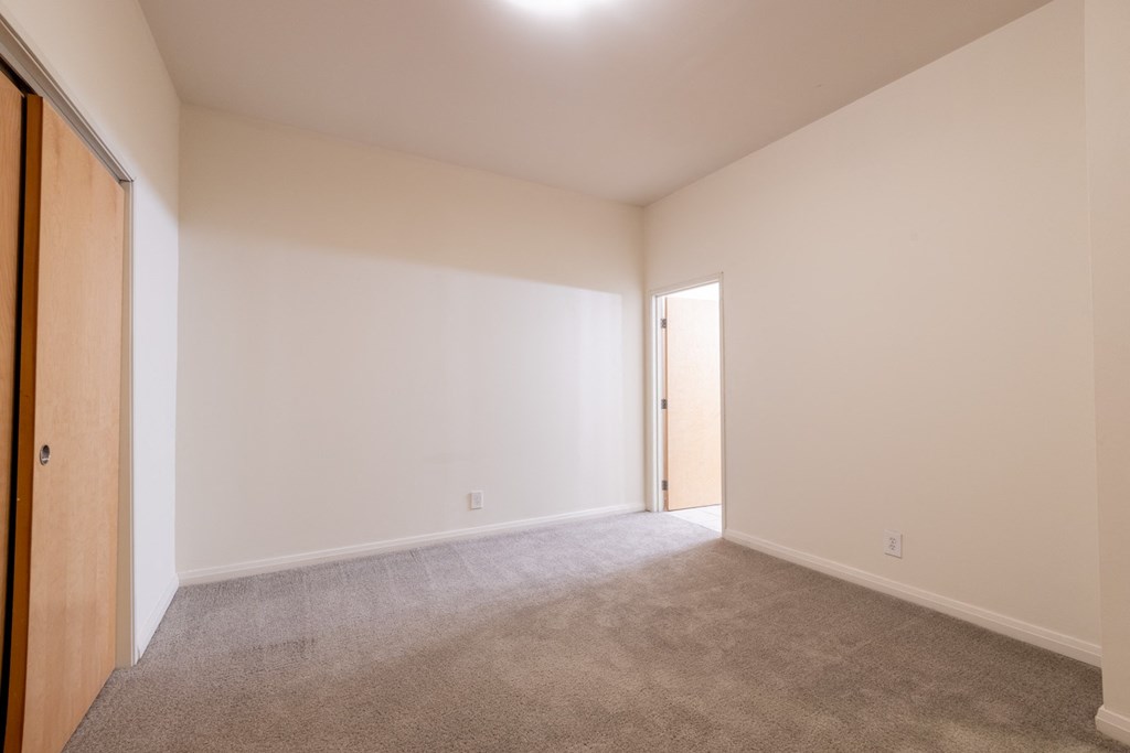a bedroom with white walls and carpet at 26 West, Managed by Buckingham Urban Living, Indianapolis