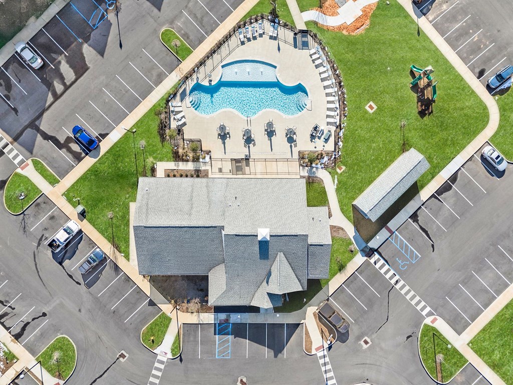 A large building with a pool in front of it.