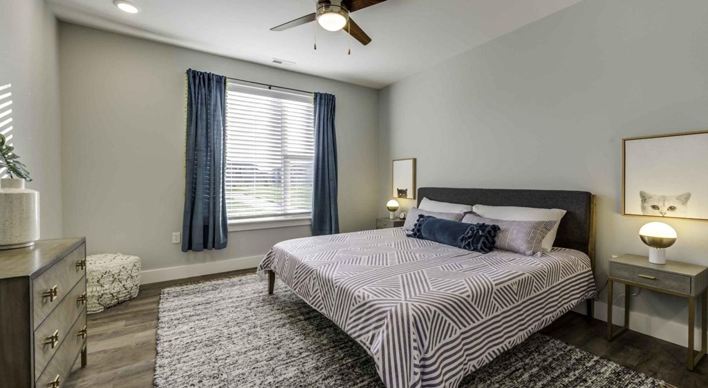 a bedroom with a bed and a ceiling fan at Echo Park at Perry Crossing Apartments, Plainfield, 46168