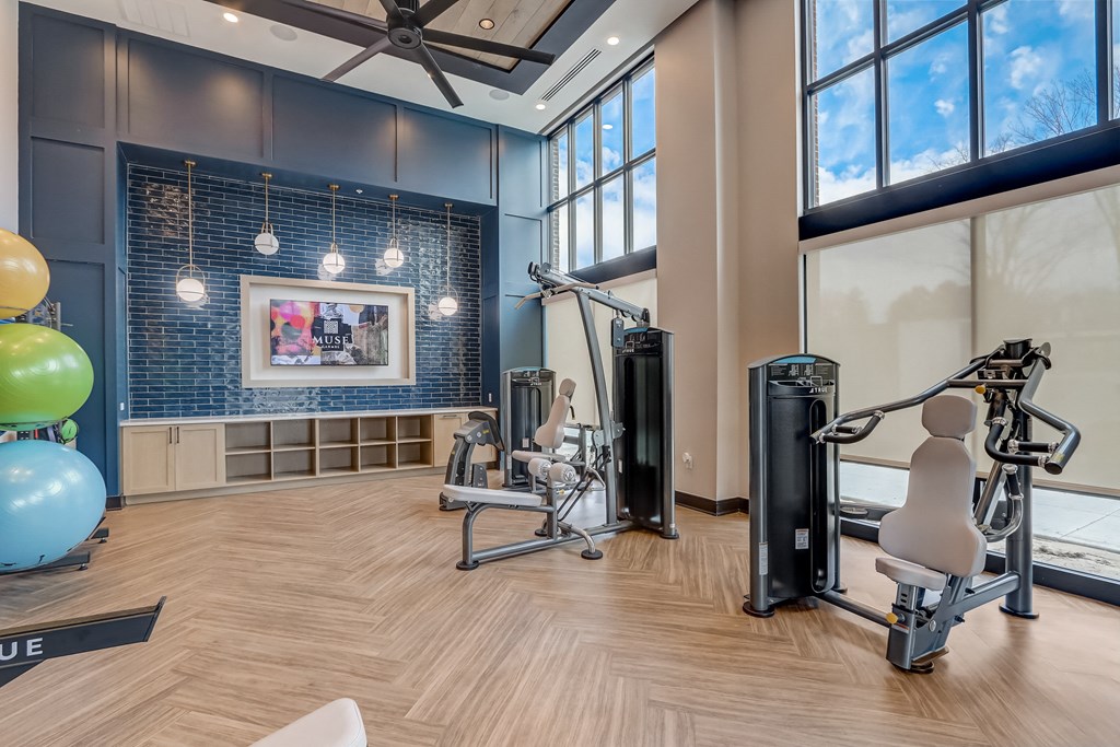 a gym with exercise equipment and a large window