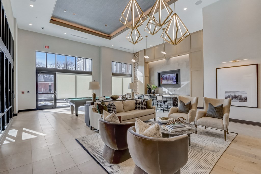 a living room with couches and chairs and a table and a pool