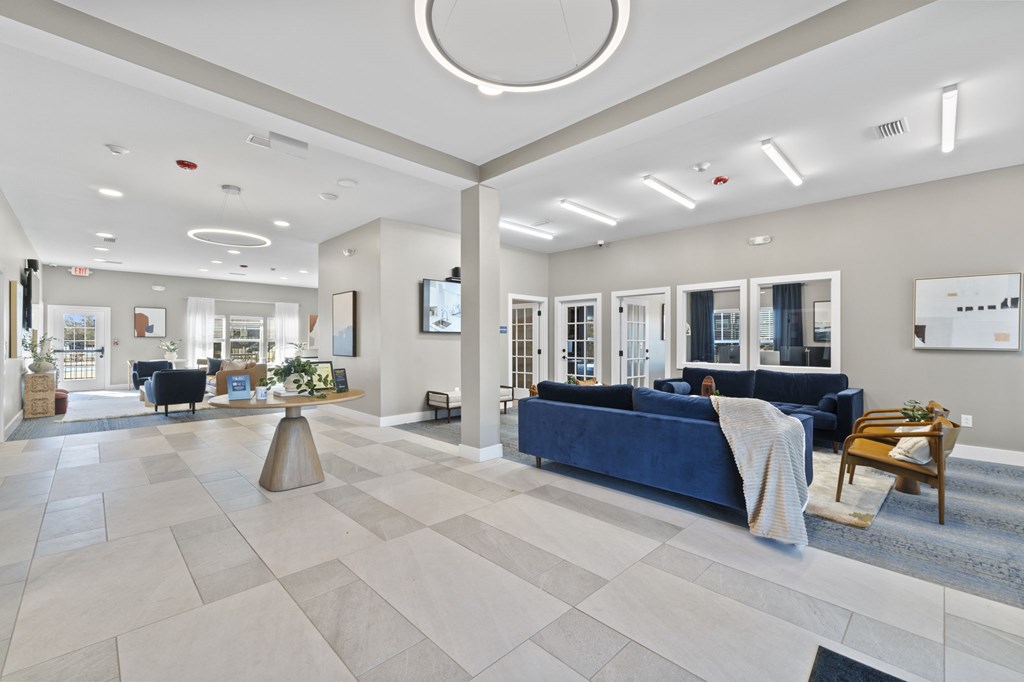 A spacious living room with a blue couch and a television.