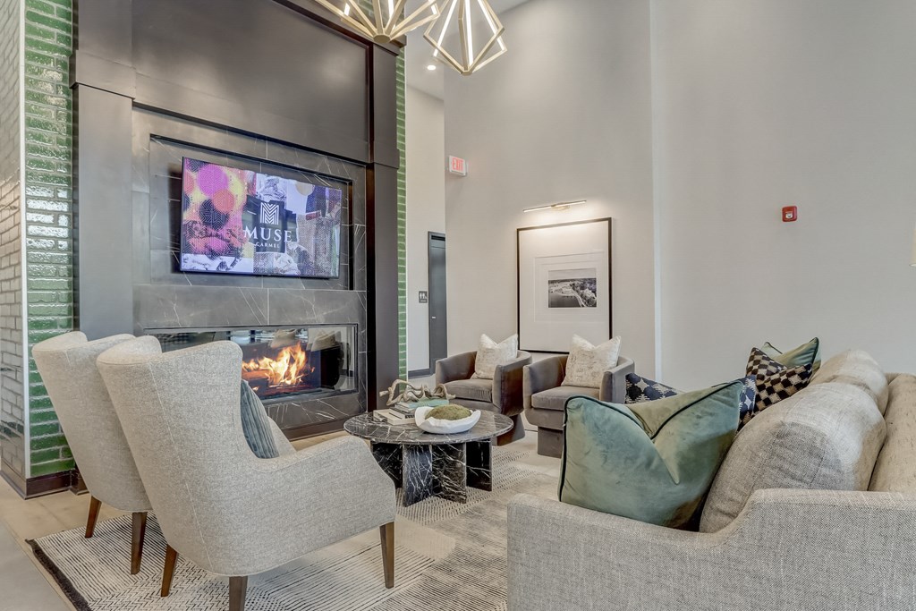 a living room with couches and chairs and a fireplace
