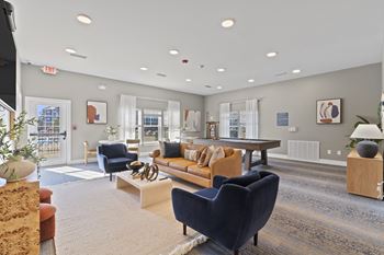 A spacious living room with a variety of furniture and decor.