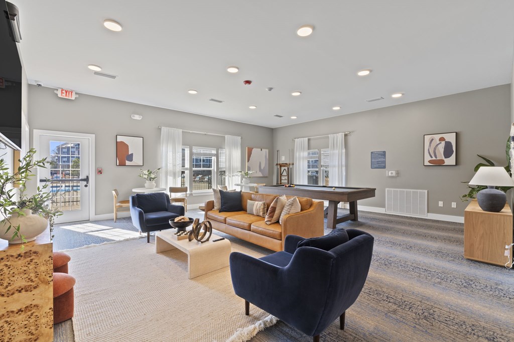 A spacious living room with a variety of furniture and decor.