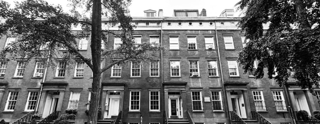 a large brick building with trees in front of it
