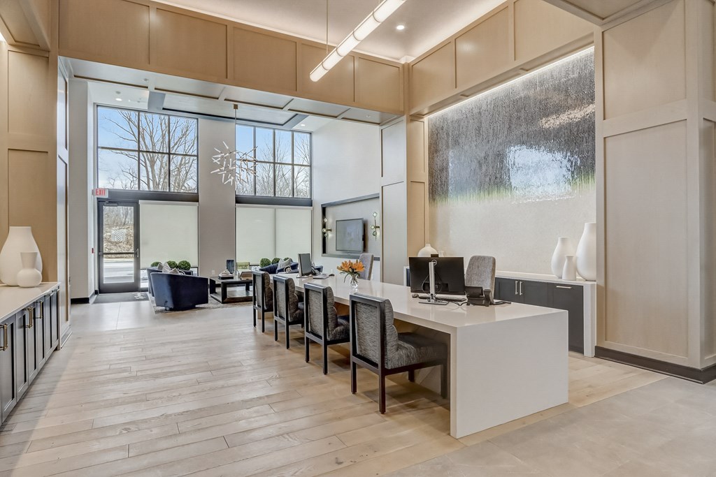 an office space with a desk and chairs and a large window