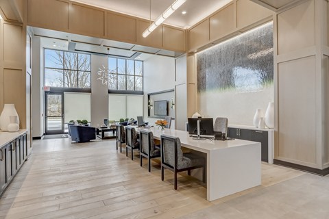 an office space with a desk and chairs and a large window