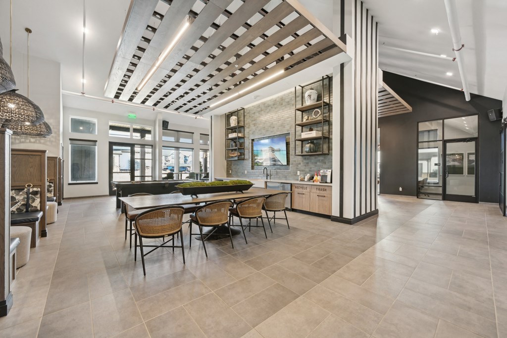 A modern dining room with a large table and chairs.