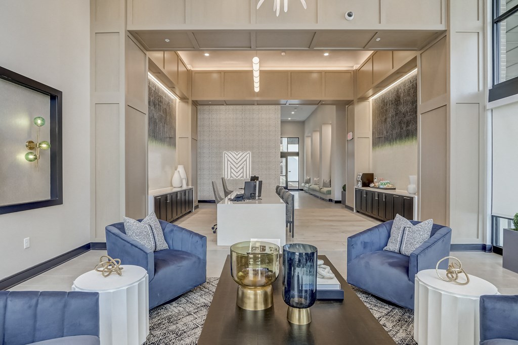 a living room with blue couches and a table