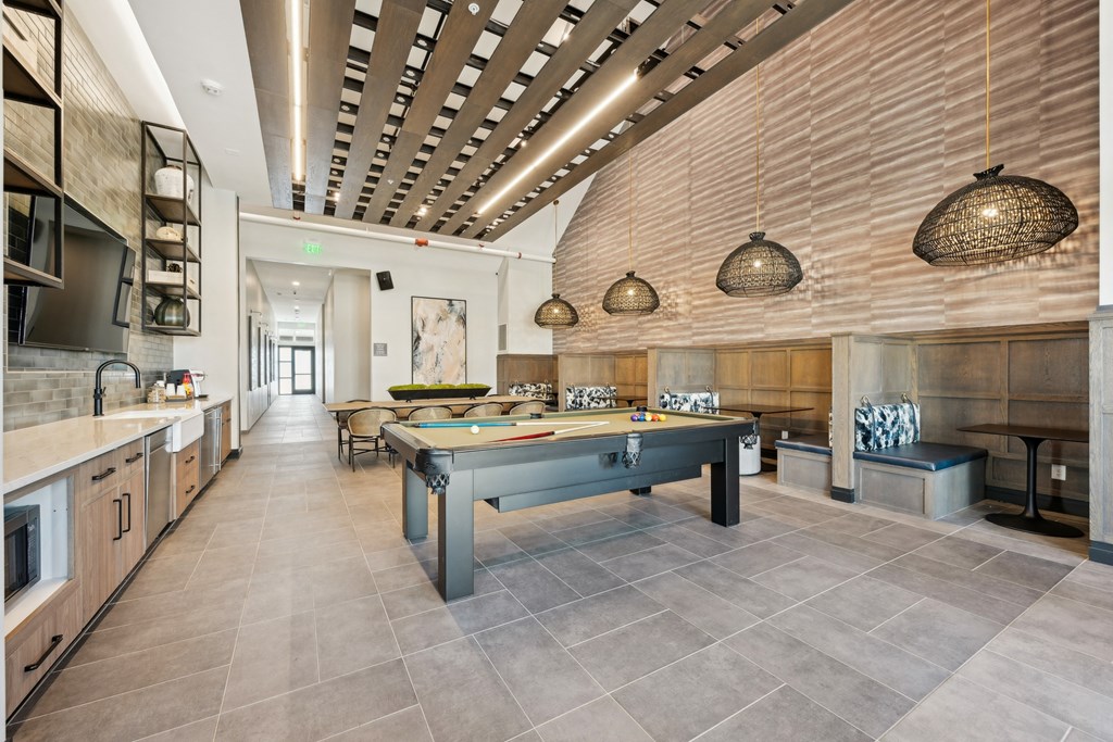 A modern kitchen with a long island in the middle.