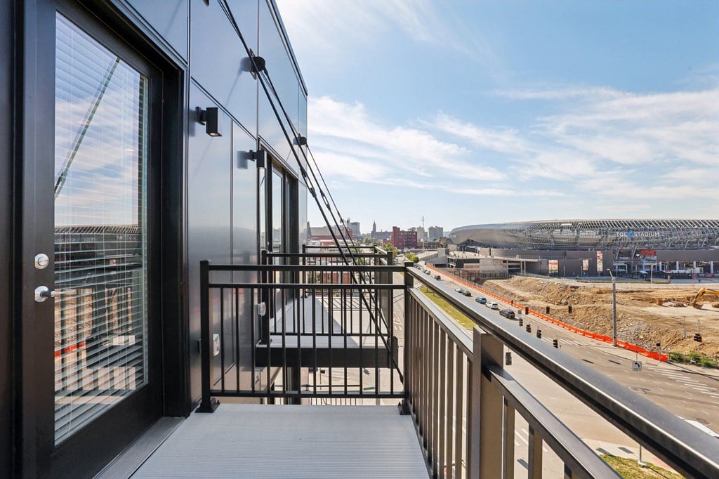 Private balcony at Contrast OTR offering TQL Stadium views and modern black metal railings overlooking Cincinnati.