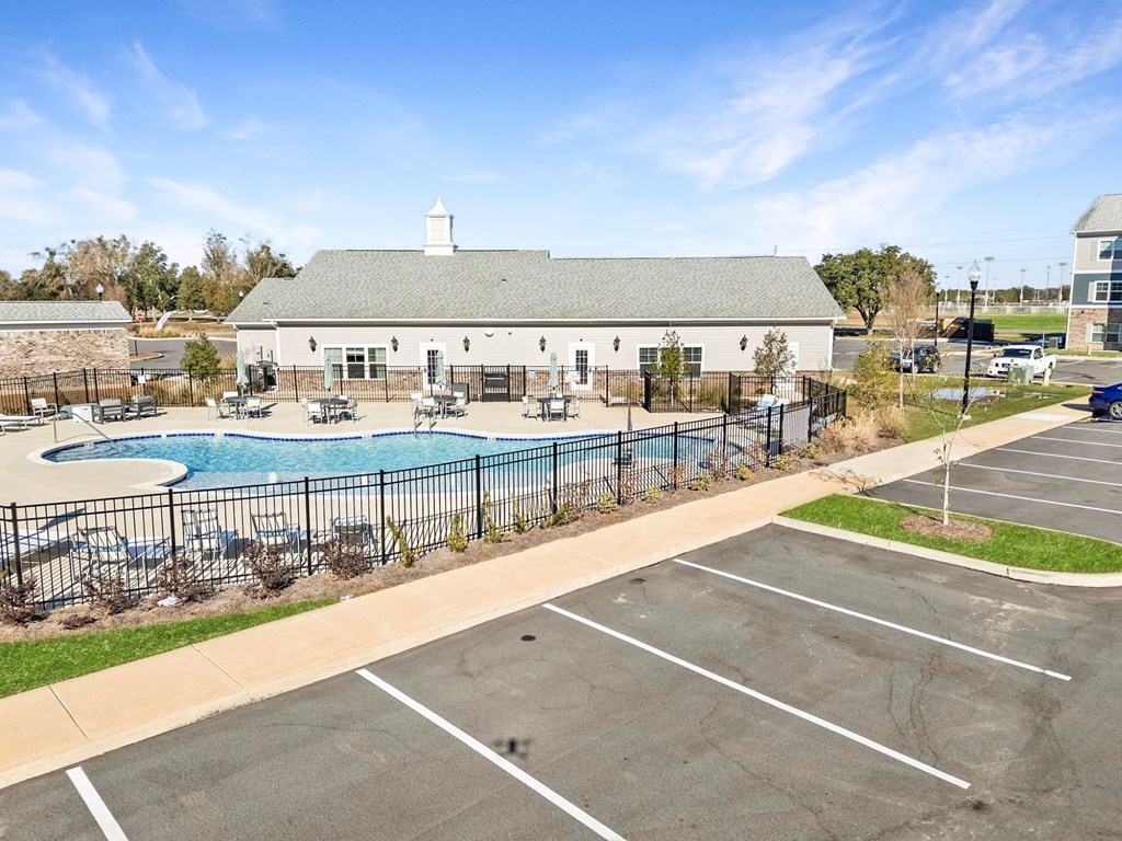 A large building with a pool in front of it.