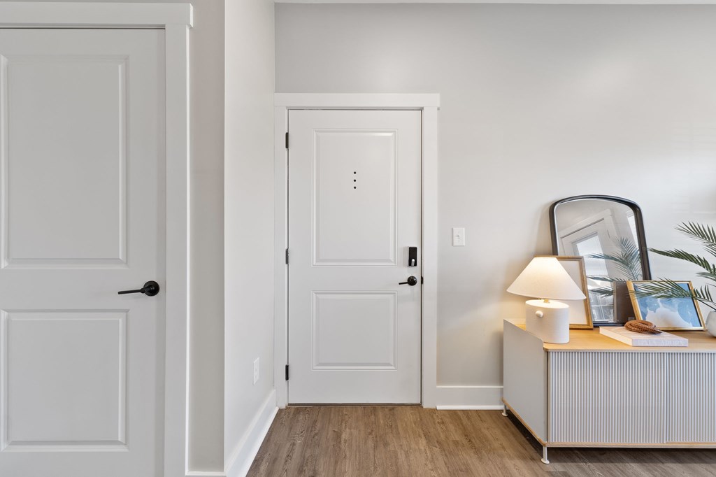 A white door is on the left and a white door with a black handle is on the right.