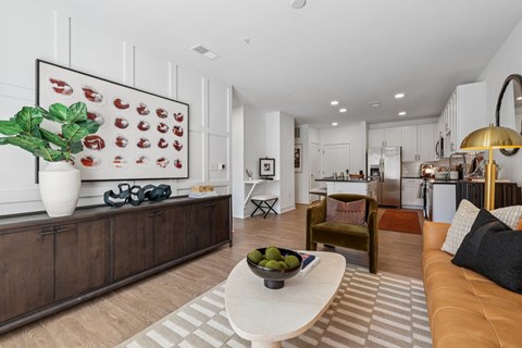 A living room with a brown sofa and a white coffee table.