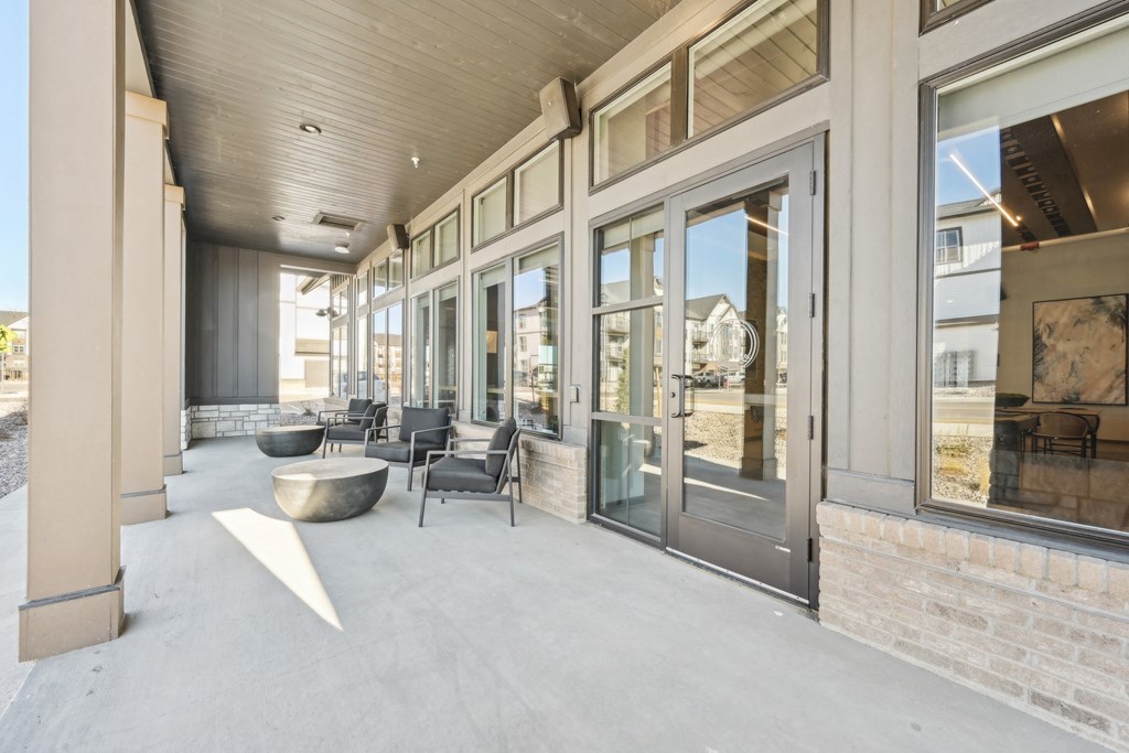 A modern building with a glass door entrance and a concrete floor.