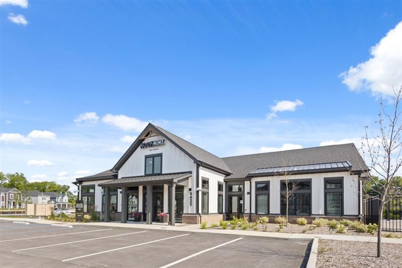 Side angle of leasing office with landscaping at Nook Nine
