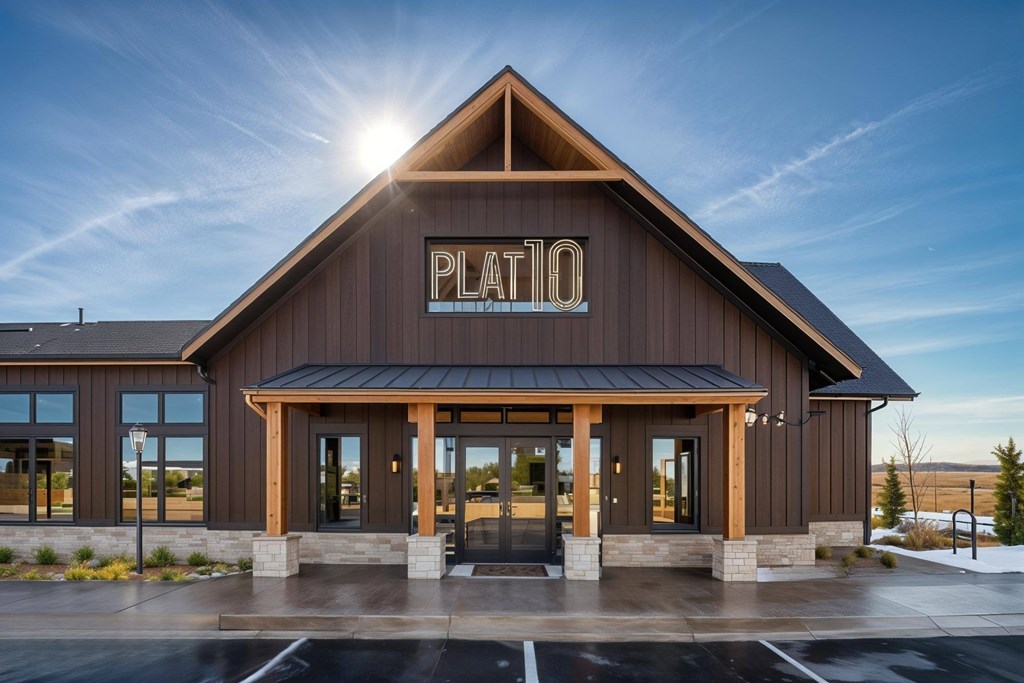 The Plato building has a dark brown facade and a black roof.