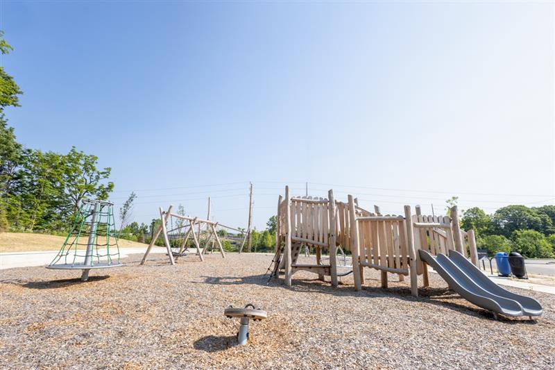 Family-friendly playground with double slides and climbing structure at Nook Nine
