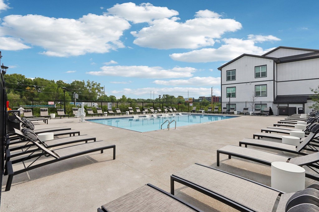 Swimming pool with lounge chairs at Nook Nine Apartments