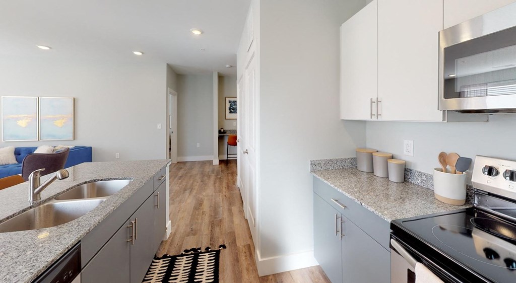 a modern kitchen with granite counter tops and stainless steel appliances at Echo Park at Perry Crossing Apartments, Plainfield, 46168