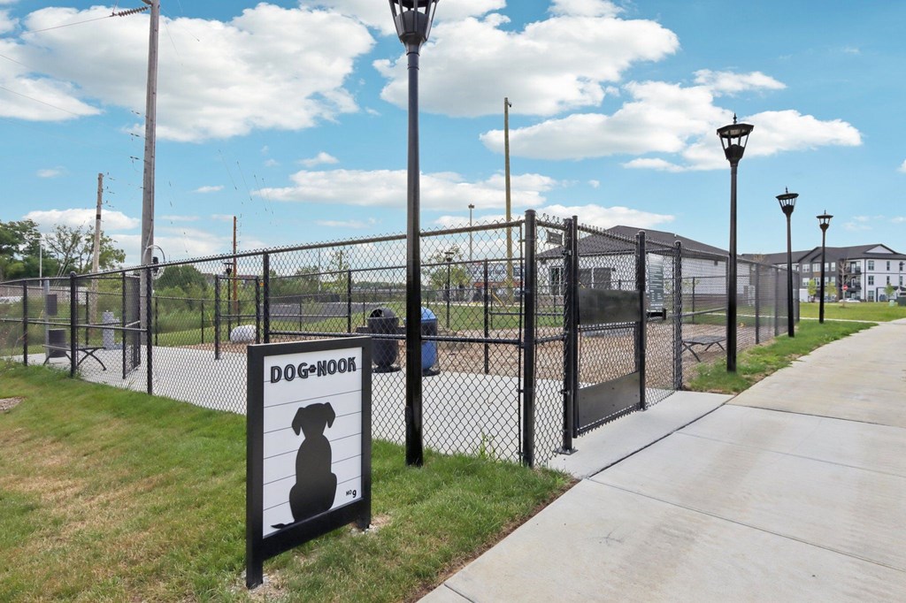 Fenced dog park with sign at Nook Nine Apartments in Northside Indianapolis