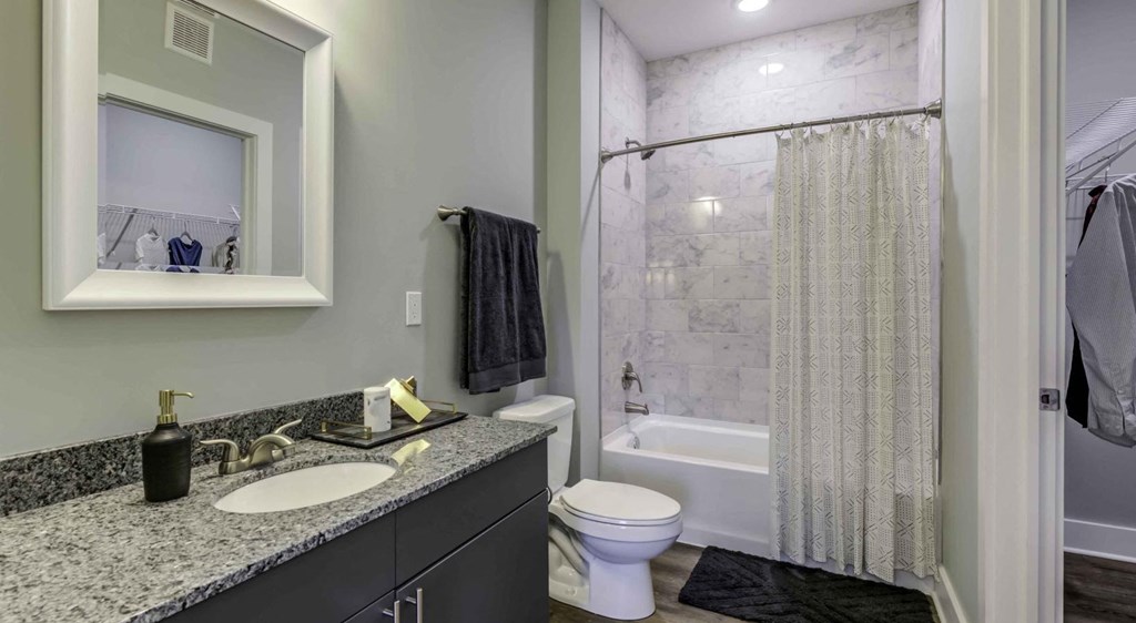 a bathroom with a sink and a shower and a toilet at Echo Park at Perry Crossing Apartments, Plainfield, Indiana