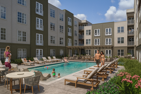 A large swimming pool surrounded by lounge chairs and people enjoying the sun at Portrait Midtown Apartments, Carmel