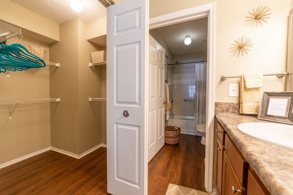 a bathroom with doors leading to closet