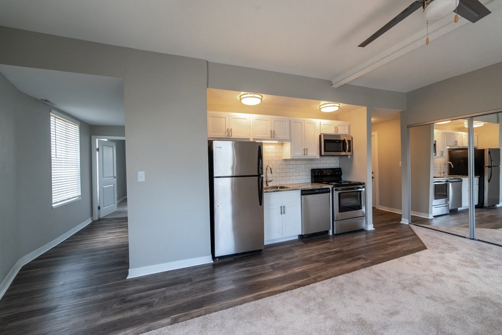 Open kitchen layout with updated appliances and granite countertops at The Argyle on Mass Ave, Indianapolis