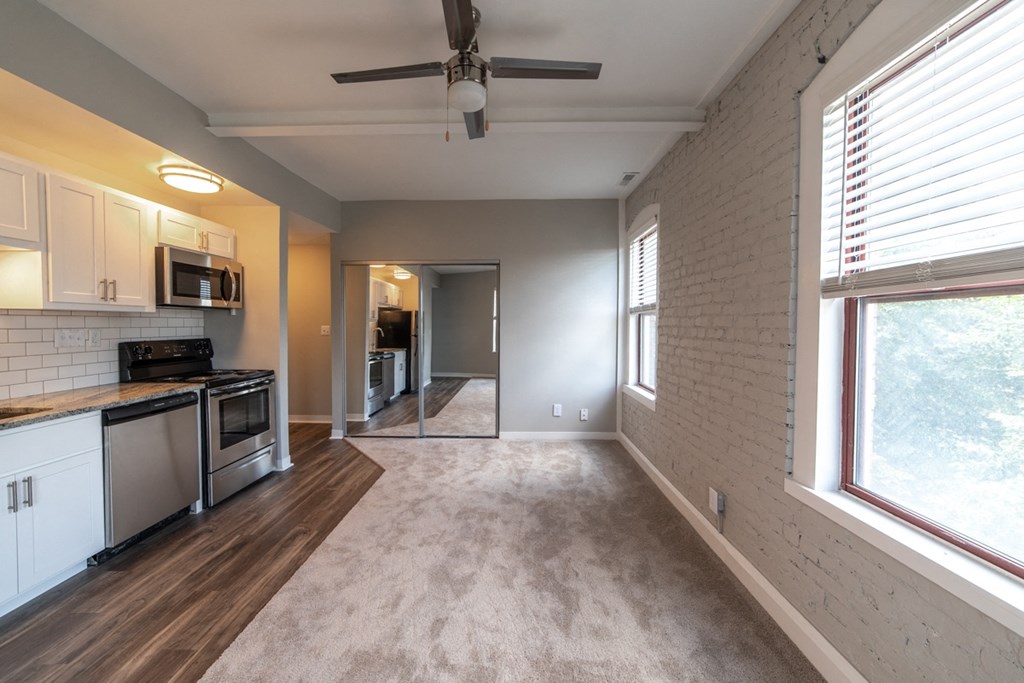 Open kitchen with updated appliances, ceiling fan, and natural light at The Argyle on Mass Ave, Indiana, 46202