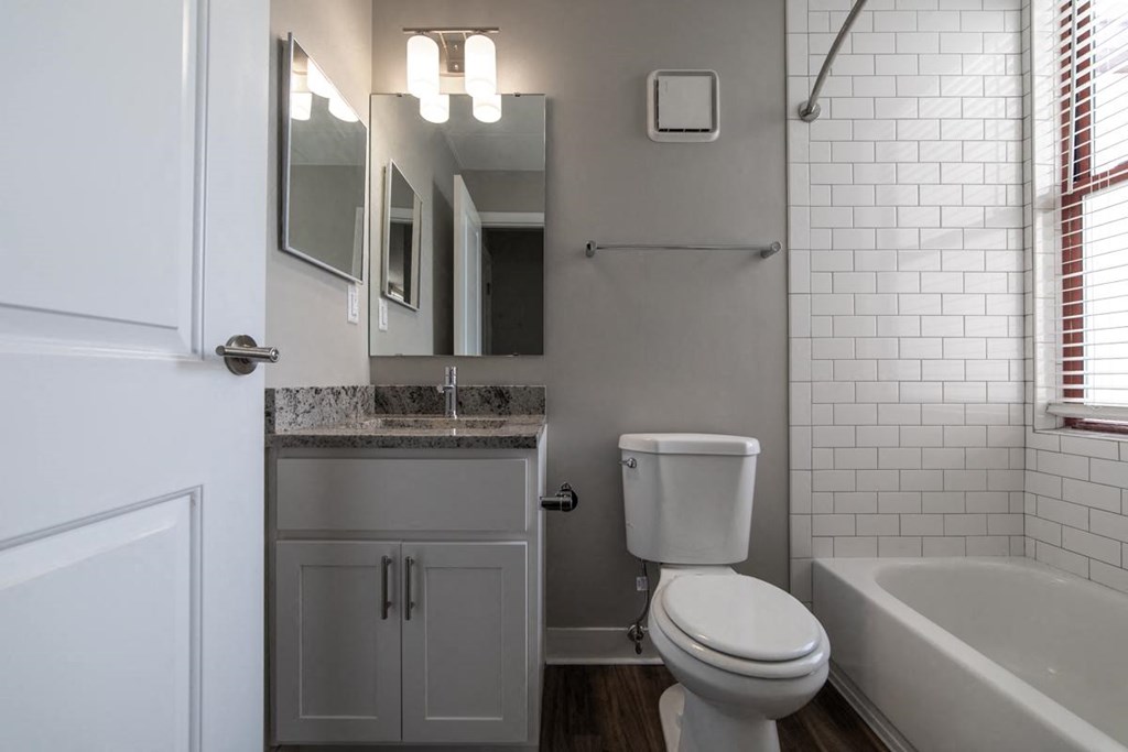 Updated bathroom with tile and granite countertops, lots of natural light at The Argyle on Mass Ave, Indianapolis, Indiana