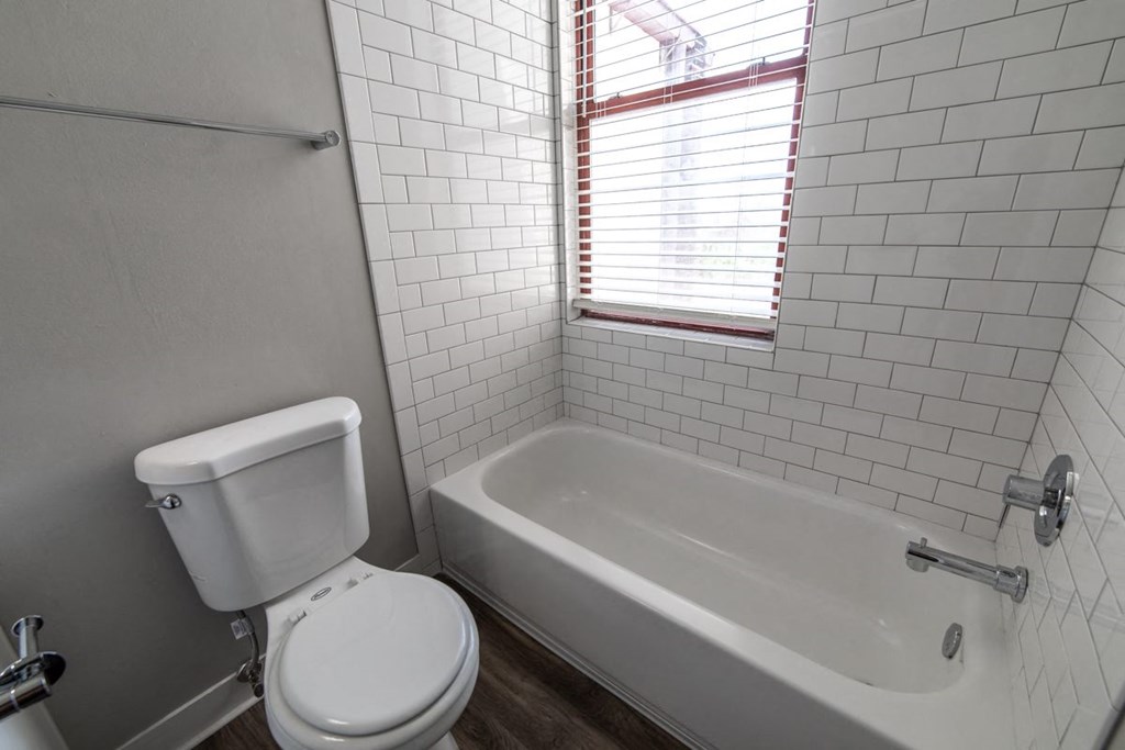 Bathroom with window and updated tiled bathtub at The Argyle on Mass Ave, Indiana, 46202