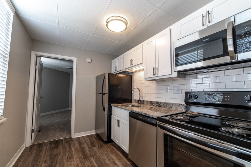 Kitchen with updated appliances, granite countertops and white cabinets at The Argyle on Mass Ave, Indiana, 46202