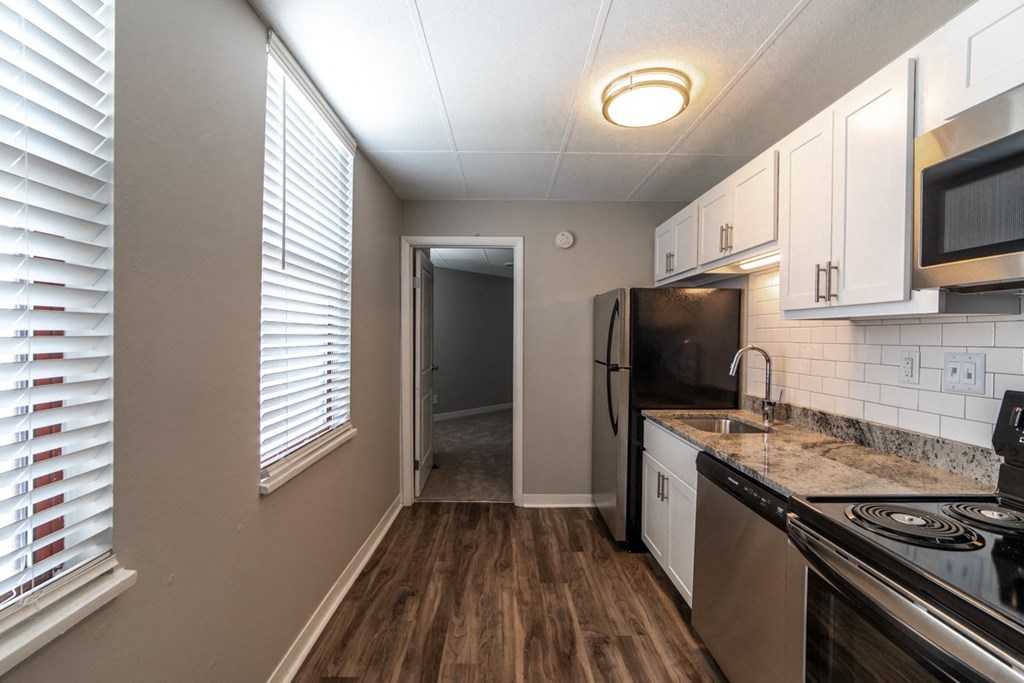 Kitchen with window and updated appliances and cabinets at The Argyle on Mass Ave, Indiana, 46202