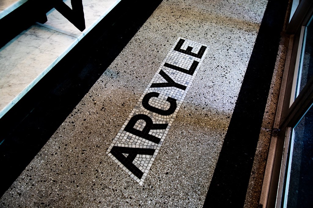 Mosaic tile of Argyle building name on building entry floor at The Argyle on Mass Ave, Indiana
