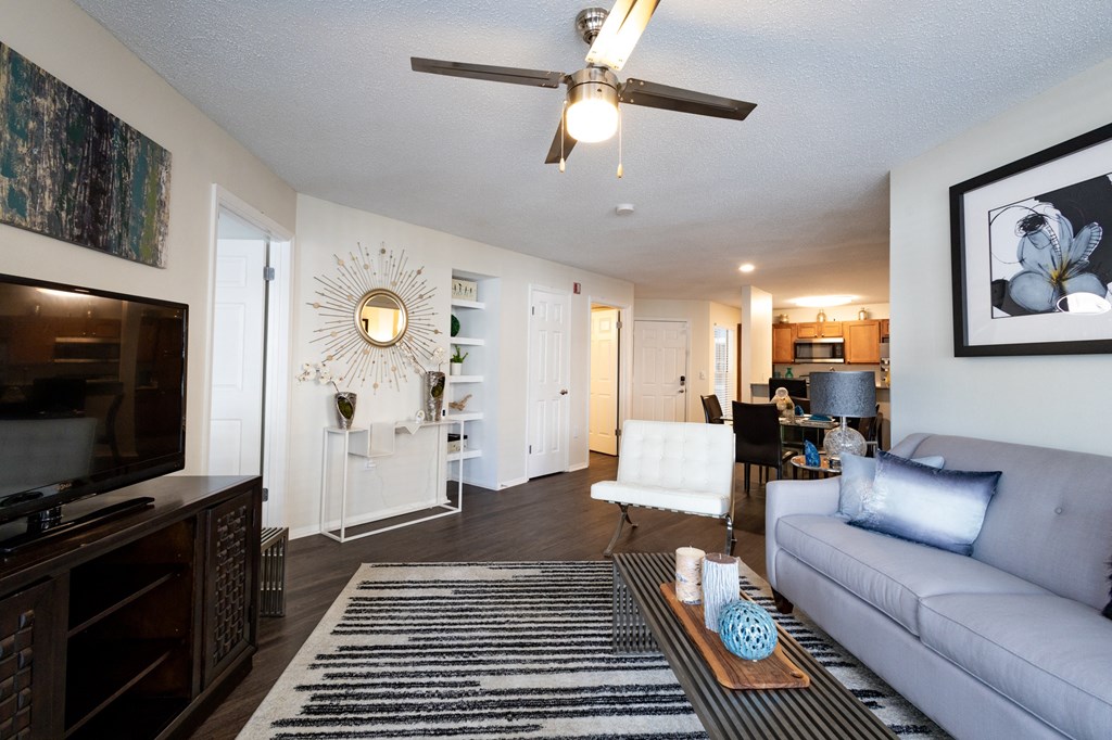 a living room with a couch and a ceiling fan