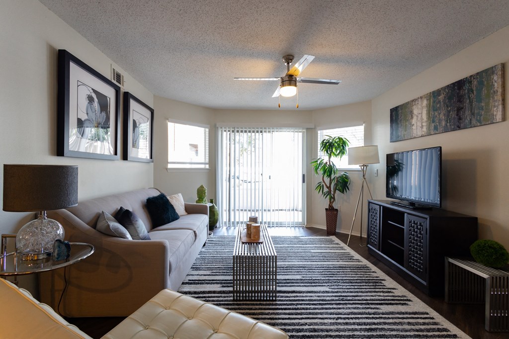 a living room with a white couch and a television
