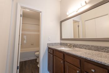 an empty bathroom with a sink and a mirror