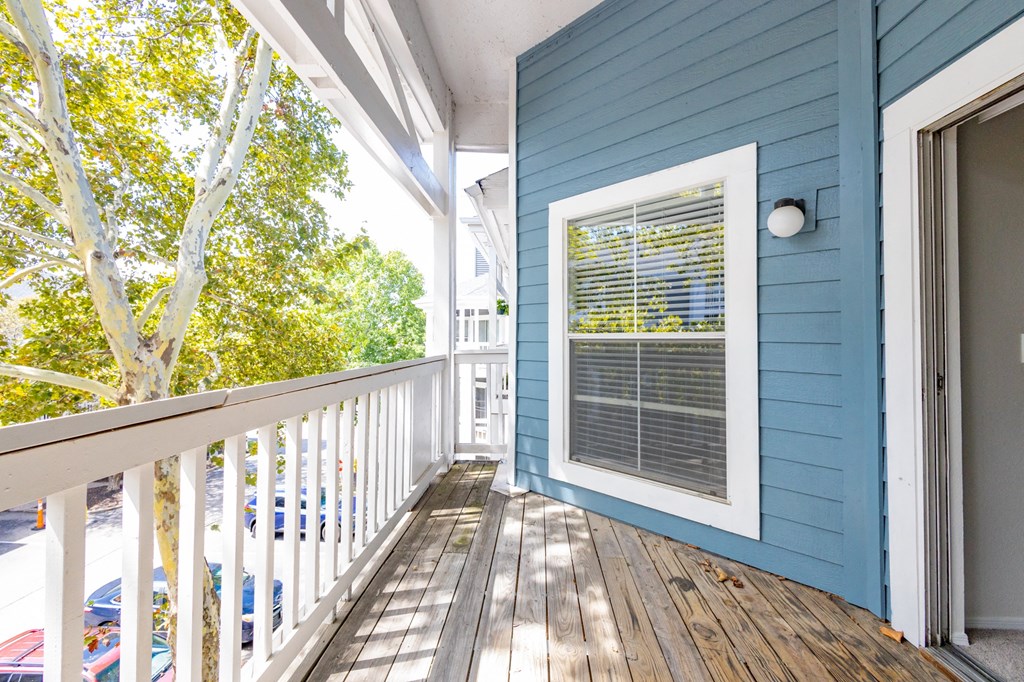 a blue house with a deck and a window