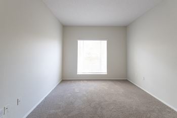 an empty room with a light shining through a window