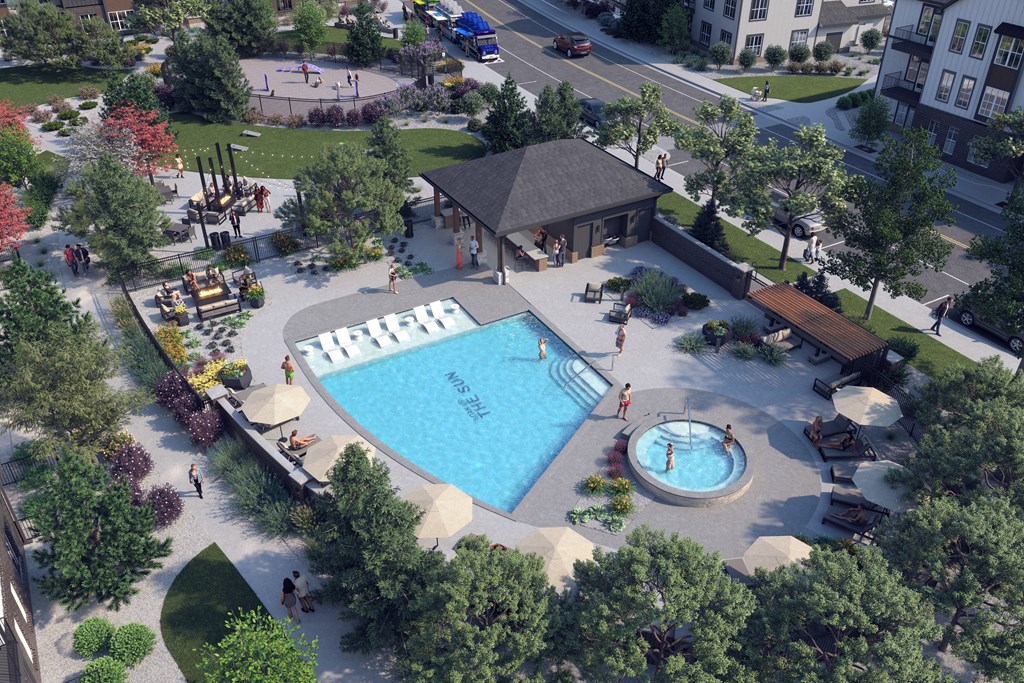 an aerial view of a pool and spa in a park with a building in the background