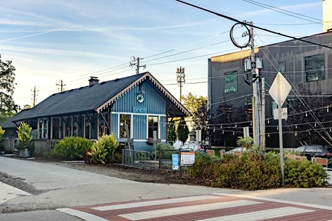 A blue building with a sign that says "bar" on it.