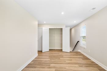 A room with a wooden floor and white walls. at Mural Lewis Center, Lewis Center, 43035