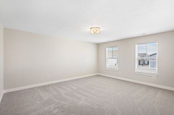 A room with a carpeted floor and two windows. at Mural Lewis Center, Ohio