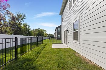 A white house with a black fence and green grass. at Mural Lewis Center, Ohio, 43035
