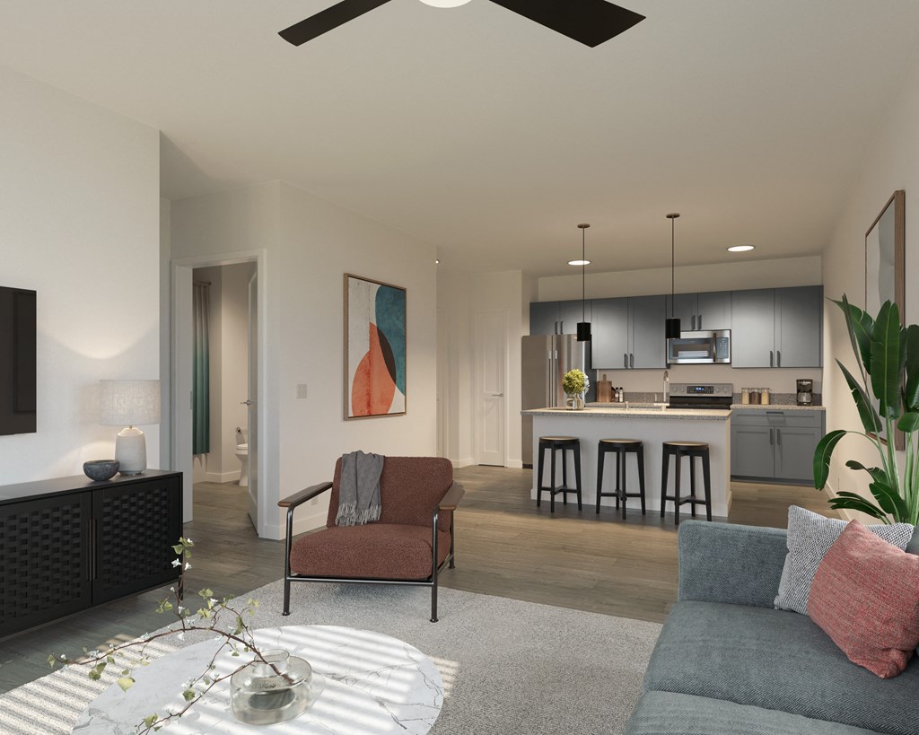 a living room and kitchen in an open floor plan