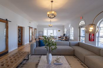 a living room with a couch and a rug