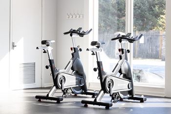 three spin bikes parked in a row in front of a window