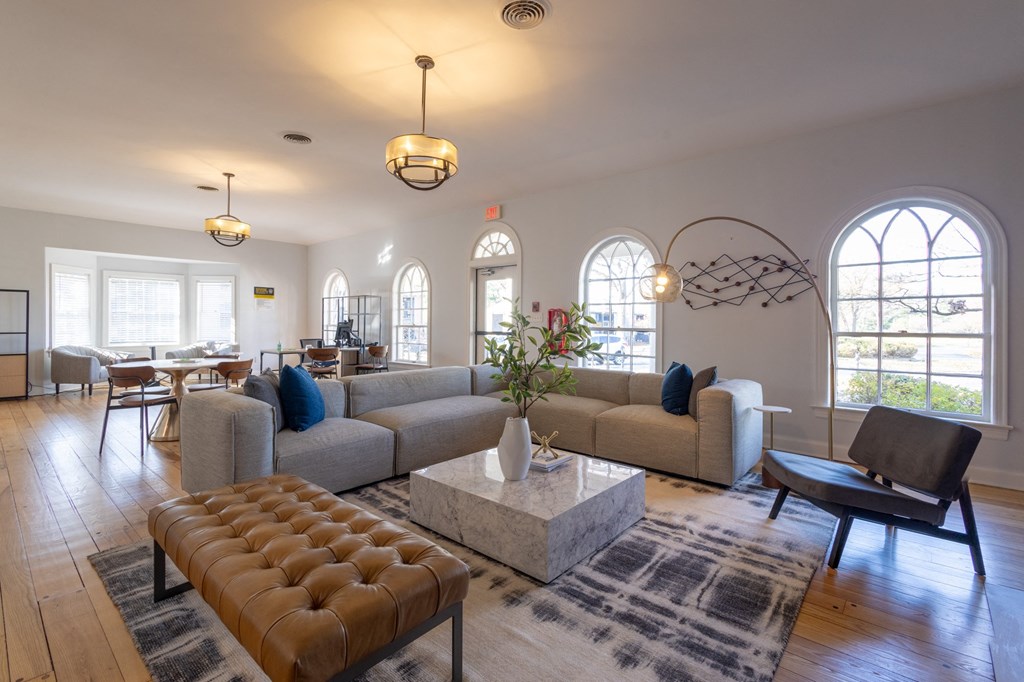 a living room with couches and chairs and a table